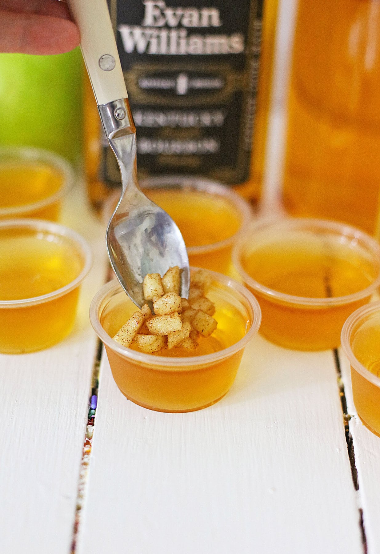 Putting the apples on the Apple Cider Bourbon Shots.