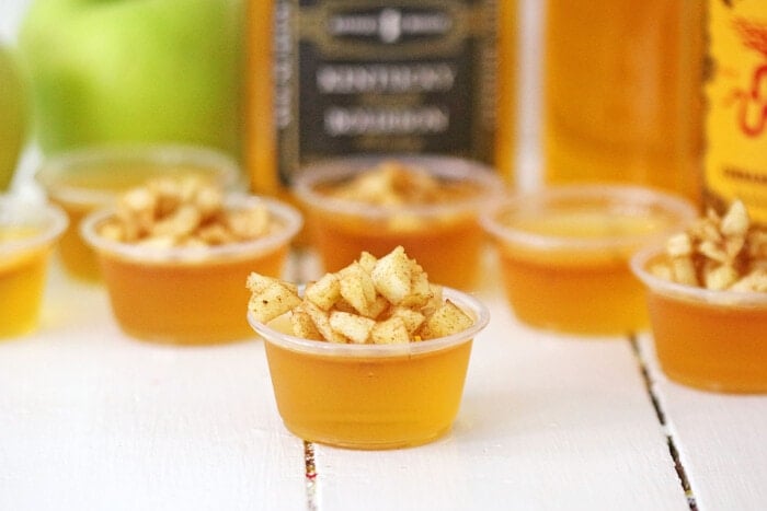 Apple Cider Bourbon Shots on a white table.