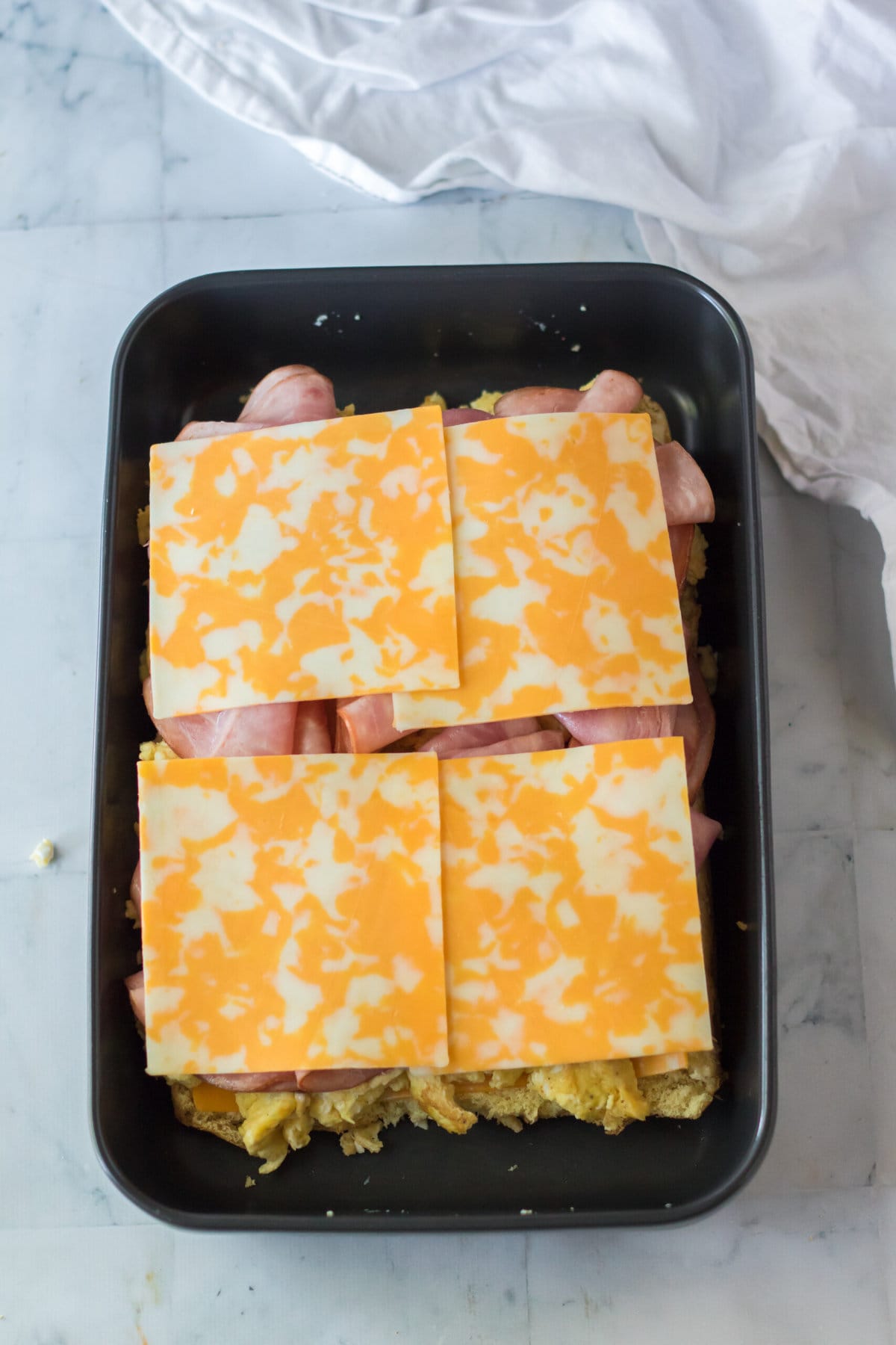Adding the second layer of cheese.