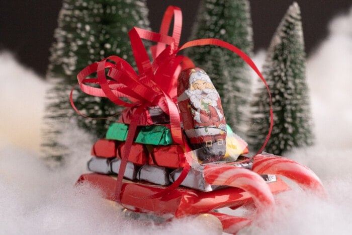 Candy Sleighs For Christmas with trees in the background.