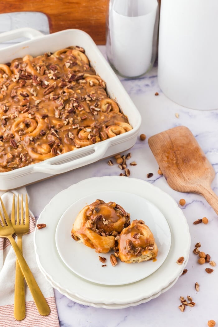 Caramel Pecan Cinnamon Rolls with pecans on the side.