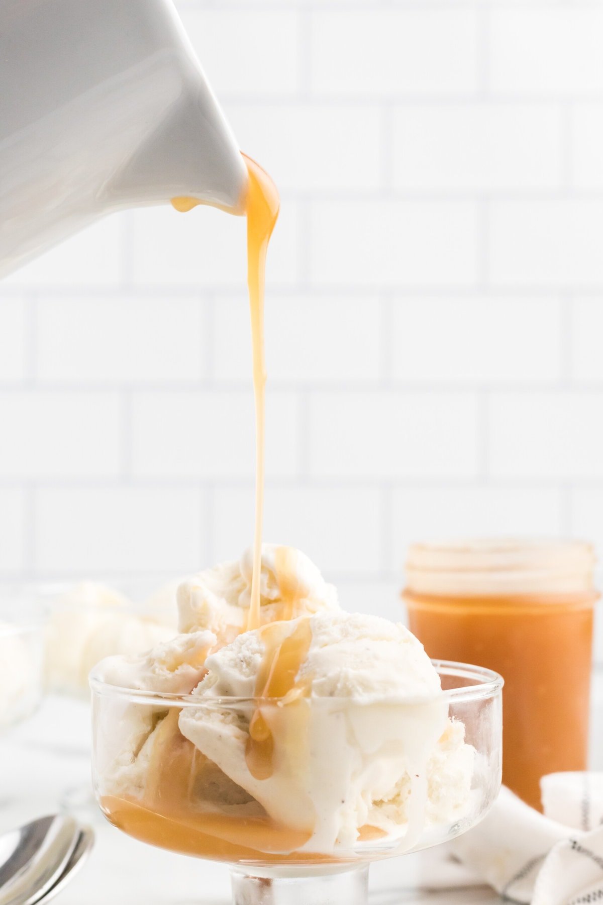Caramel Sauce being poured on ice cream.