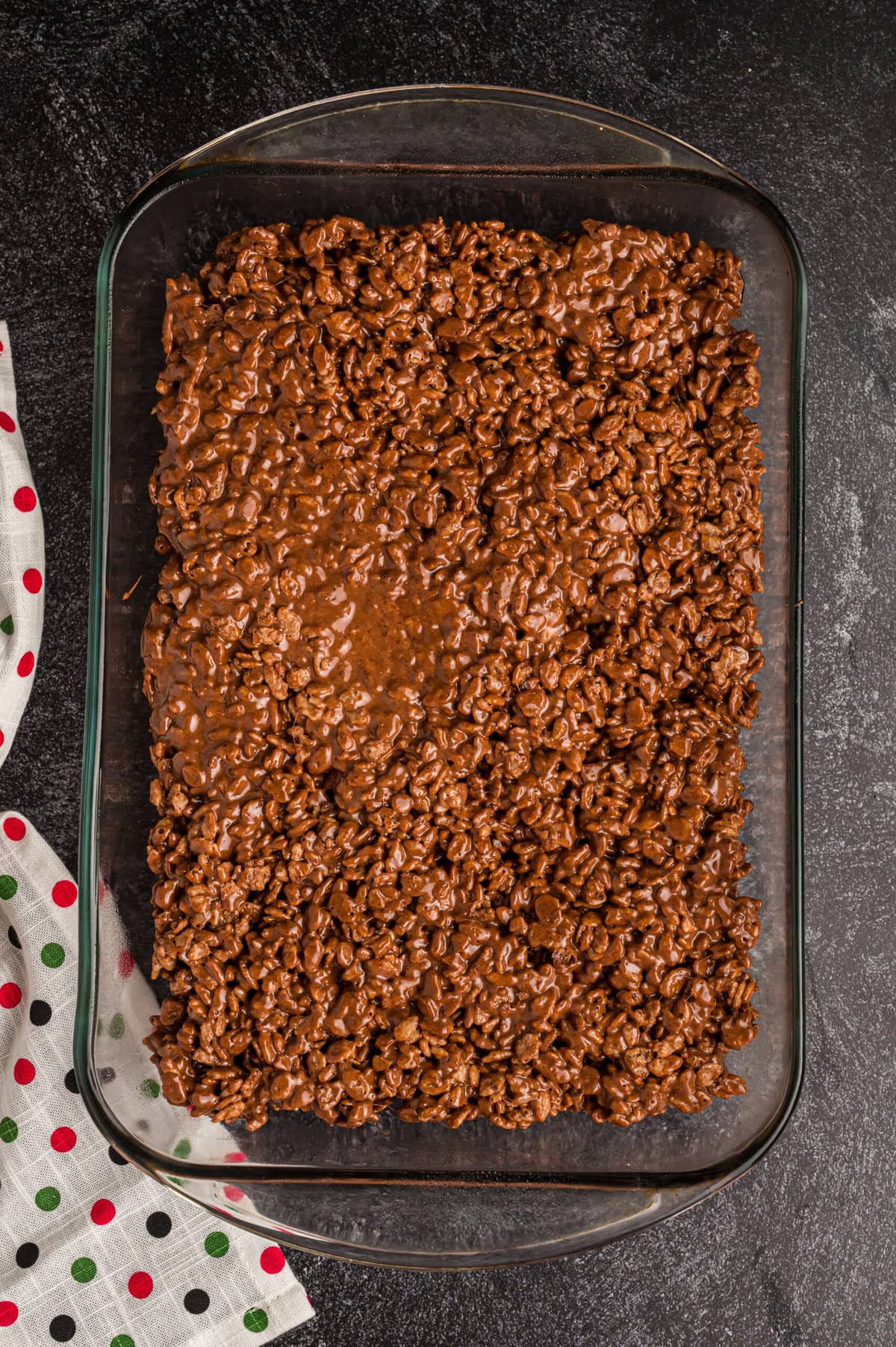 Adding the Chocolate Peppermint Rice Krispie Treats into the baking dish.
