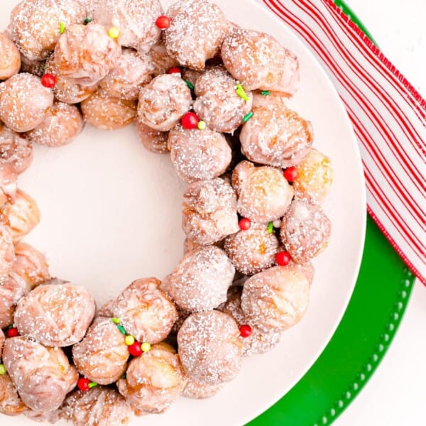 Christmas Donut Wreath on a green table cloth.