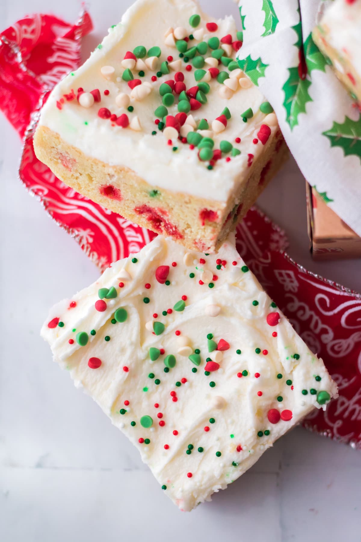 Christmas Sugar Cookie Bars on a red table cloth.