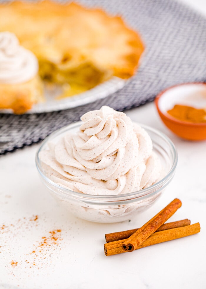 Cinnamon Whipped Cream with cinnamon sticks on the side.