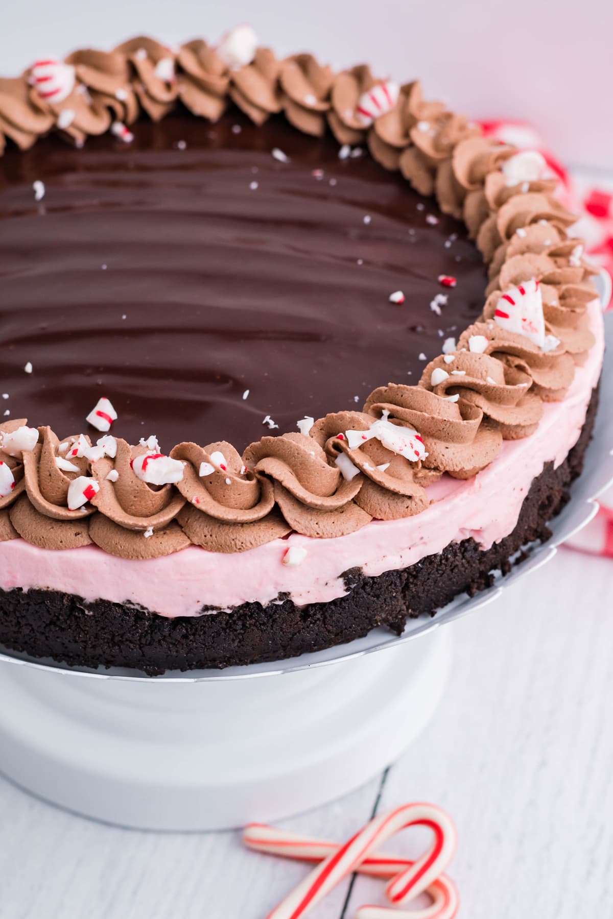 Angled view of peppermint cheesecake on a cake stand
