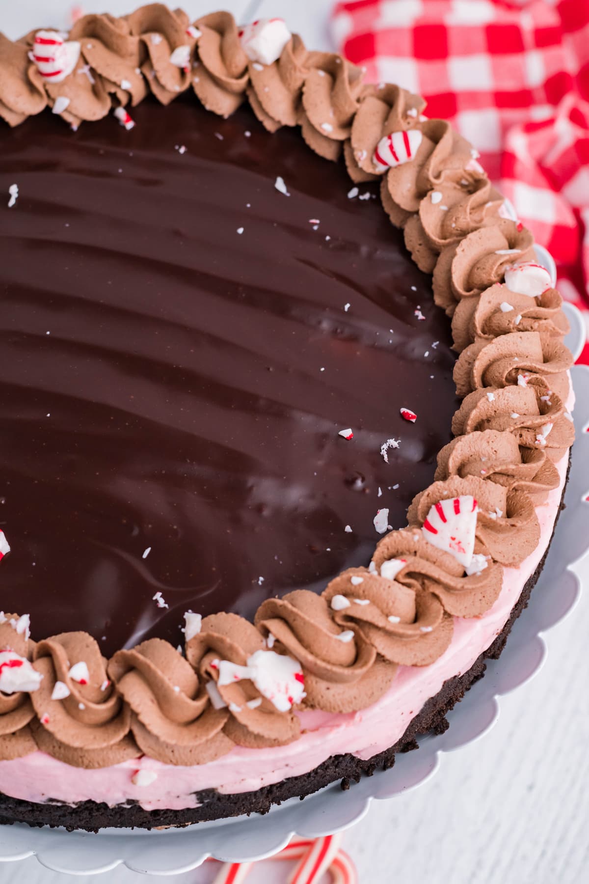 Overhead view of a peppermint cheesecake with chocolate ganache