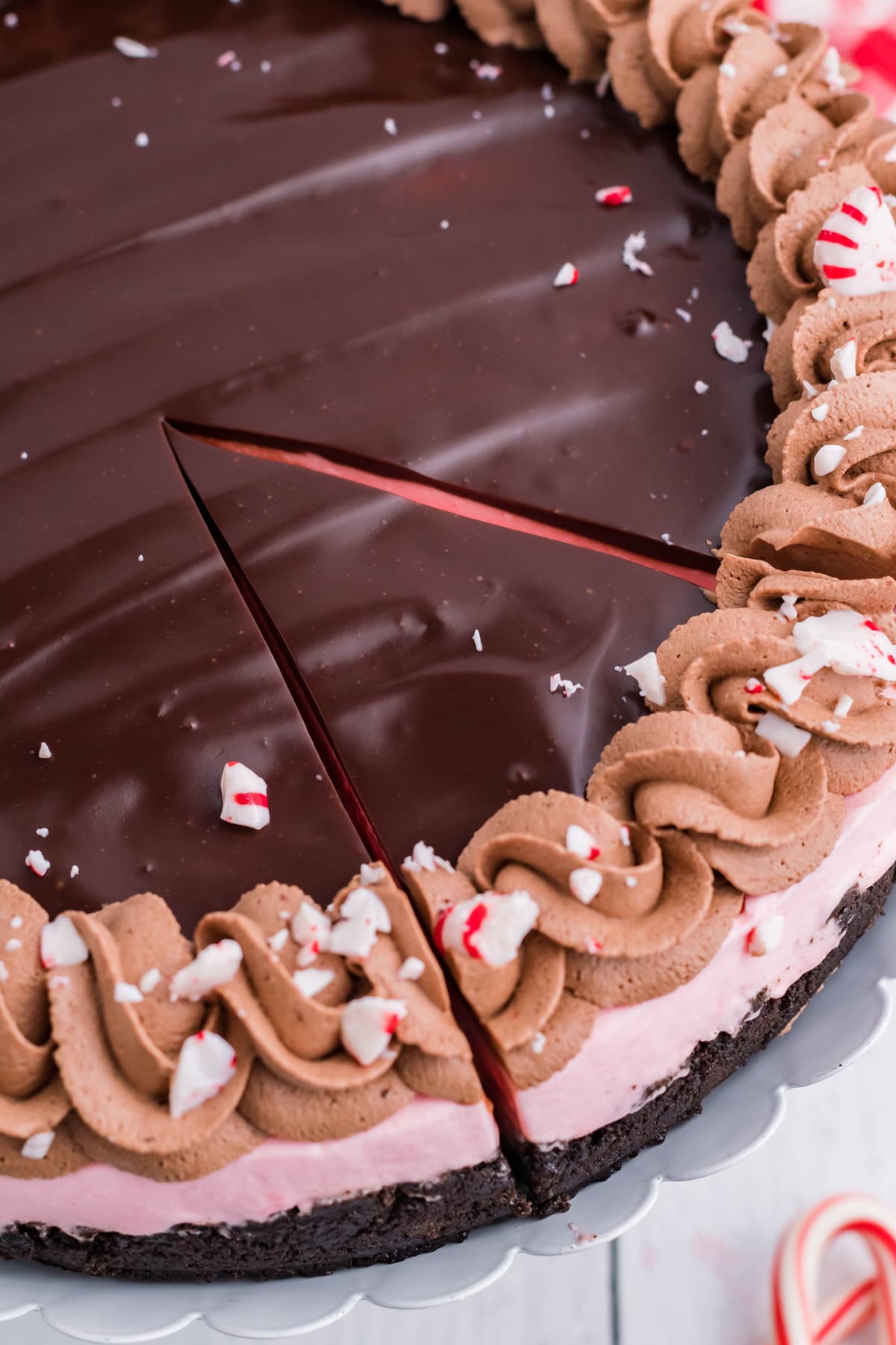 Overhead view of peppermint cheesecake with one slice cut