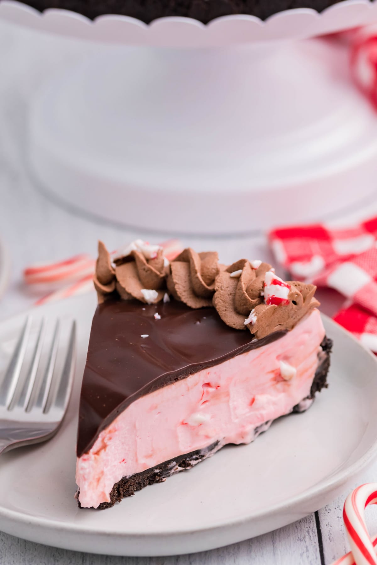 A slice of peppermint cheesecake on a white plate