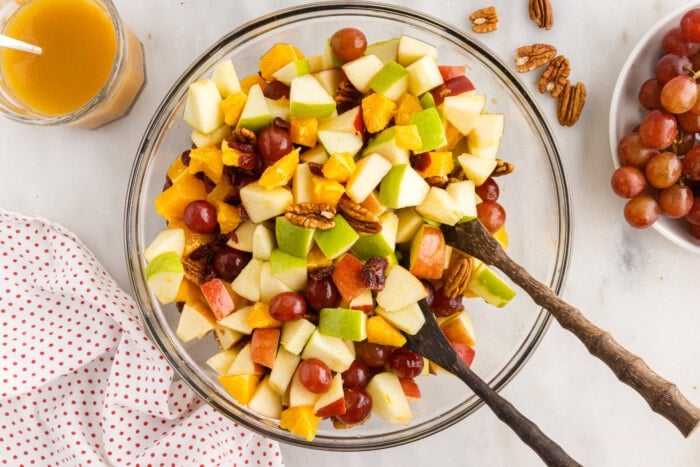 Fall Fruit Salad with wooden spoons.