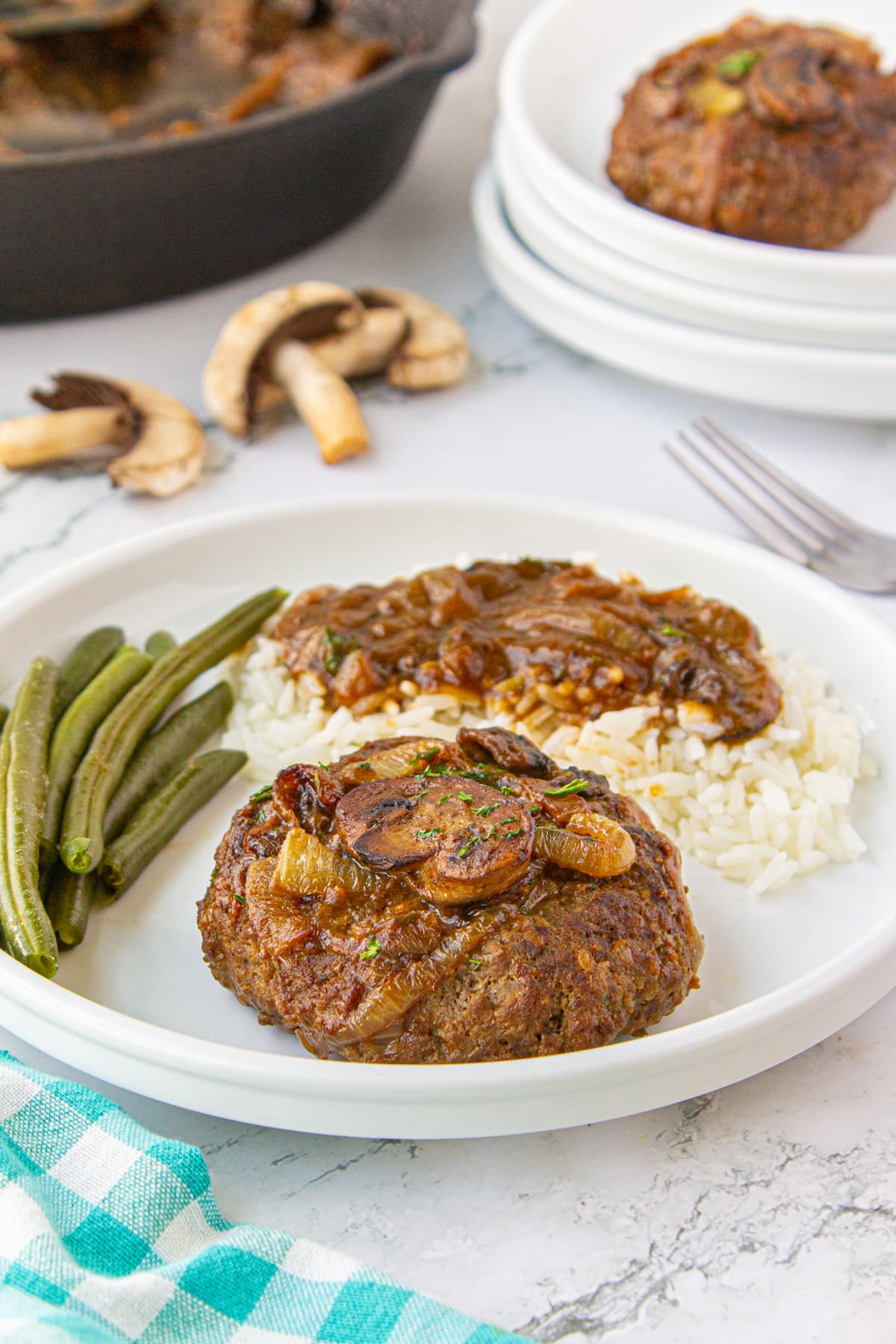 A full meal featuring Hamburger Steak on a plate.
