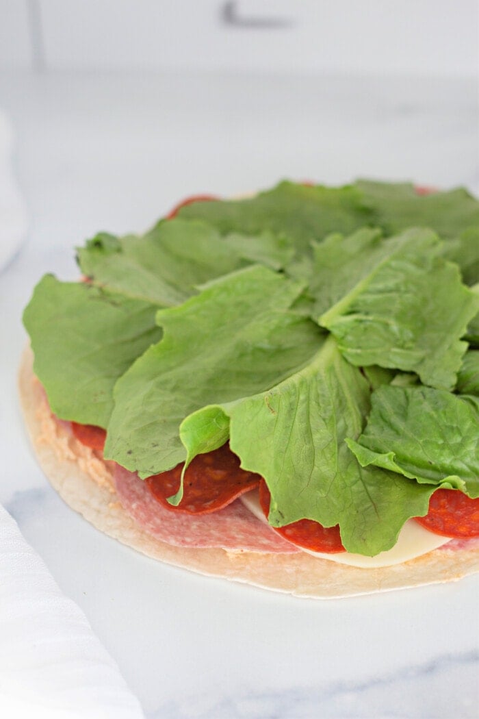 layers of pepper spread, Genoa salami, pepperoni, provolone cheese, and romaine lettuce.