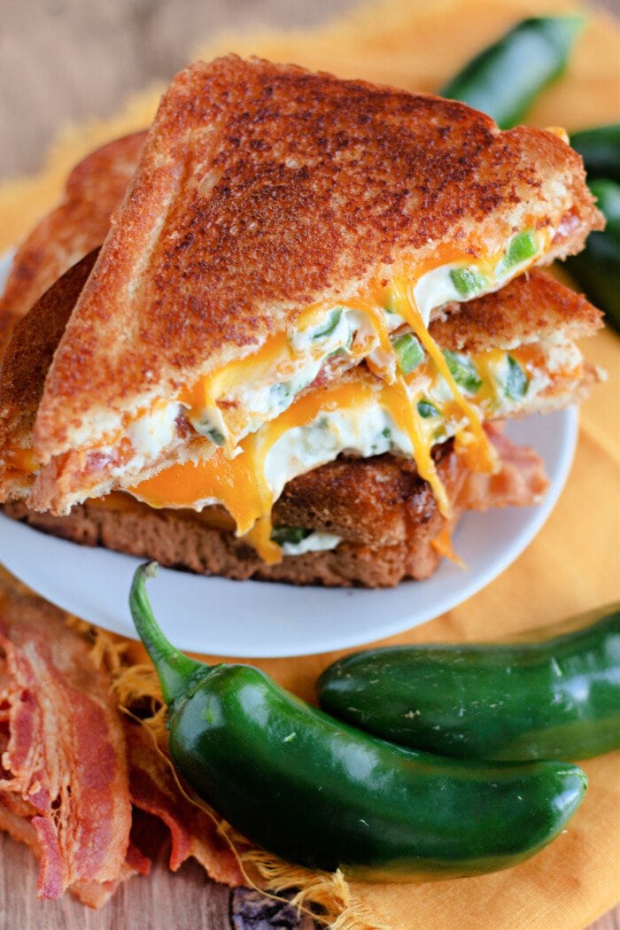 Homemade Jalapeno Popper Bacon Grilled Cheese cut into triangles.