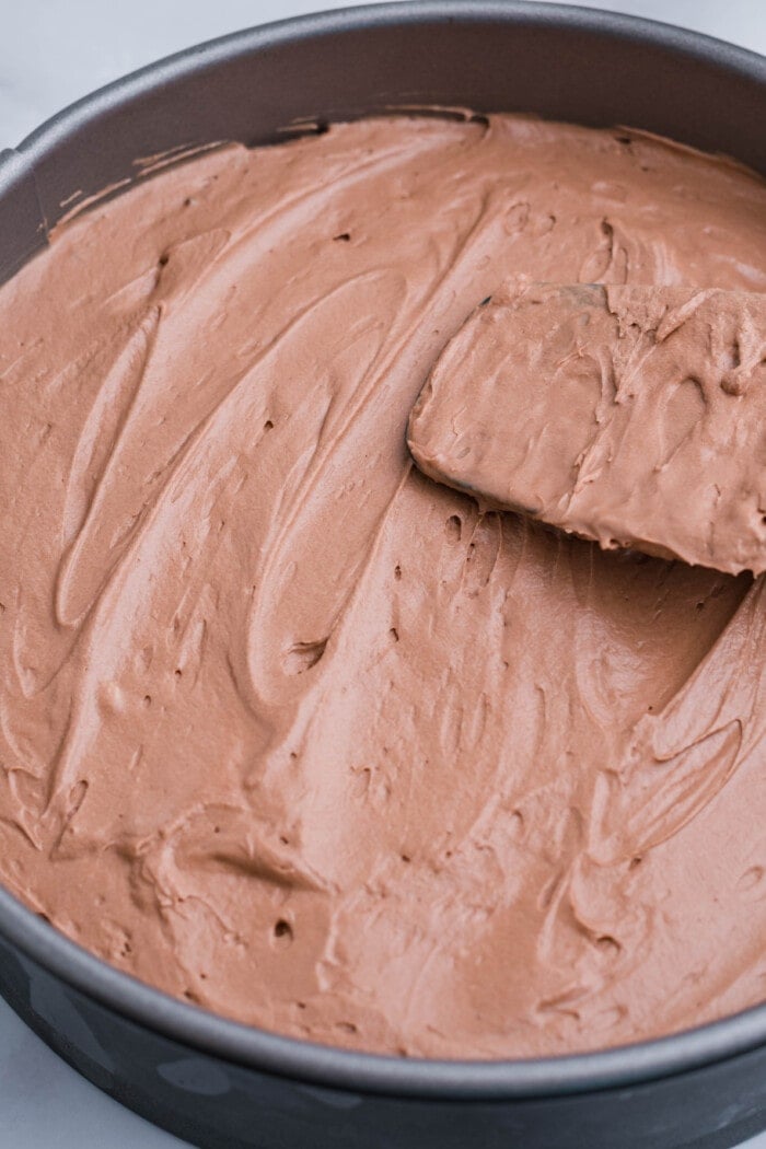 This No Bake Chocolate Cheesecake is just as rich and creamy as a traditional baked cheesecake, but so much easier to make! Adding the filling to the crust.