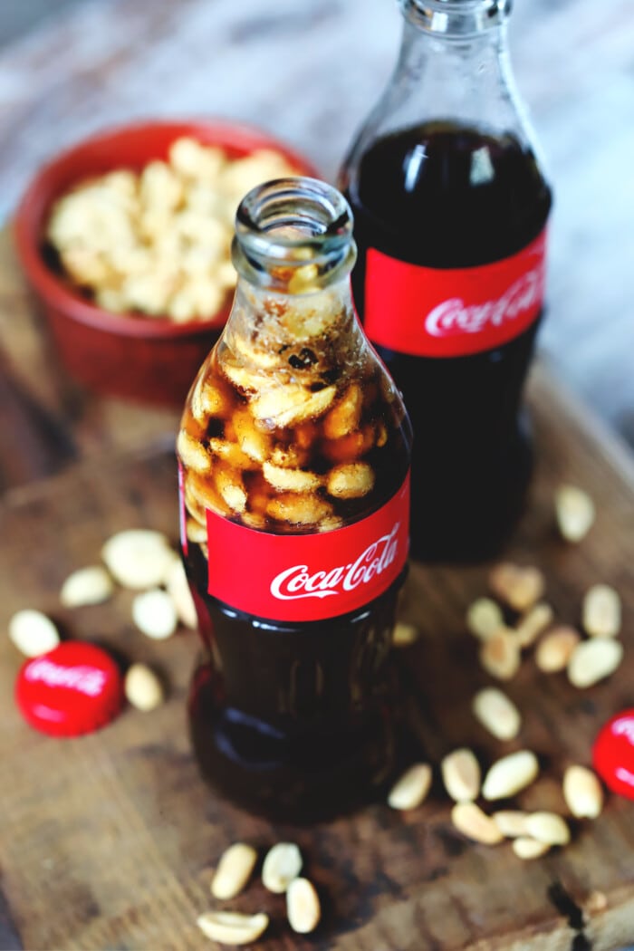 Two bottles of Peanuts and Coke.