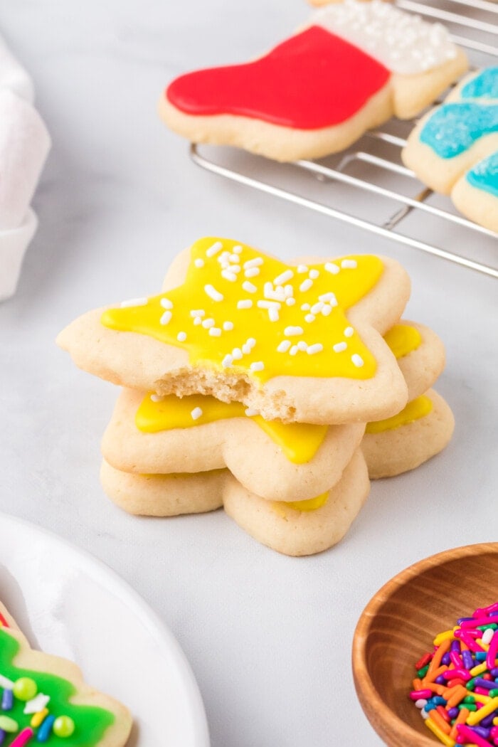 A stack of cookies with yellow Sugar Cookie Icing on top.