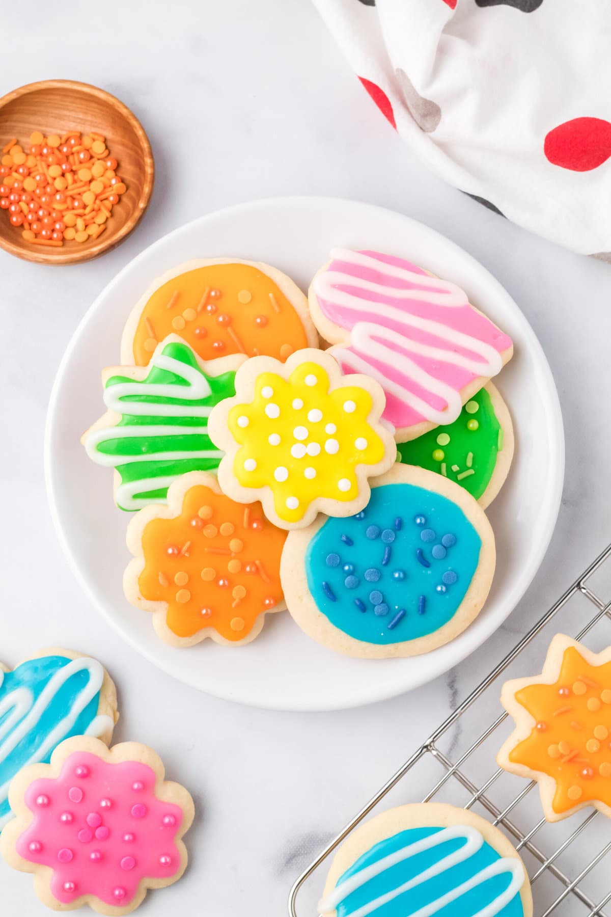 Overhead view of a plate of iced sugar cookies