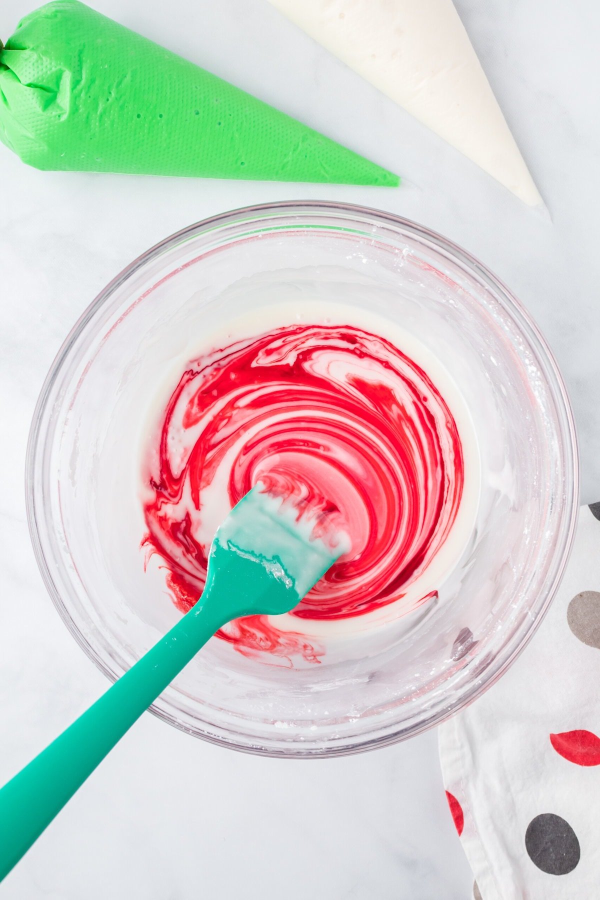 Adding red food coloring into the icing.
