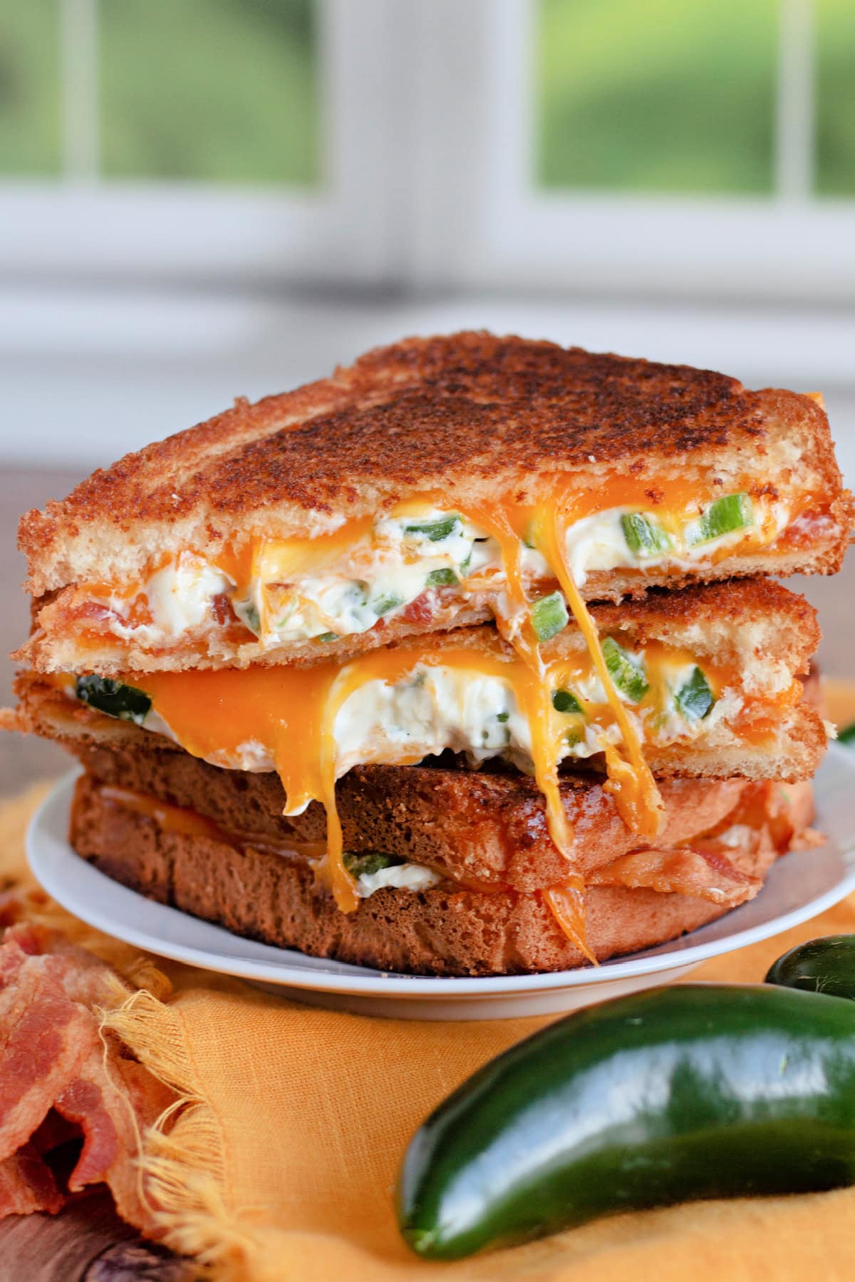Take your grilled cheese sandwich to the next level! This delicious Jalapeno Popper Bacon Grilled Cheese is a real winner. Jalapeno Popper Sandwich on a plate