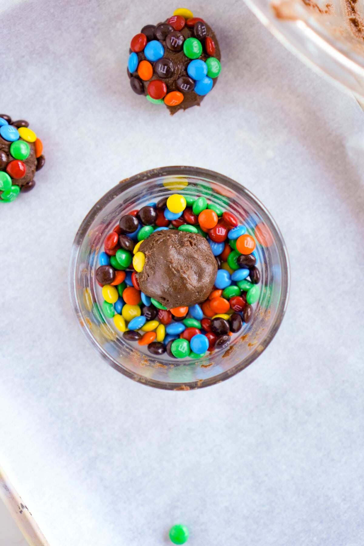 Rolling the dough in M&M's.