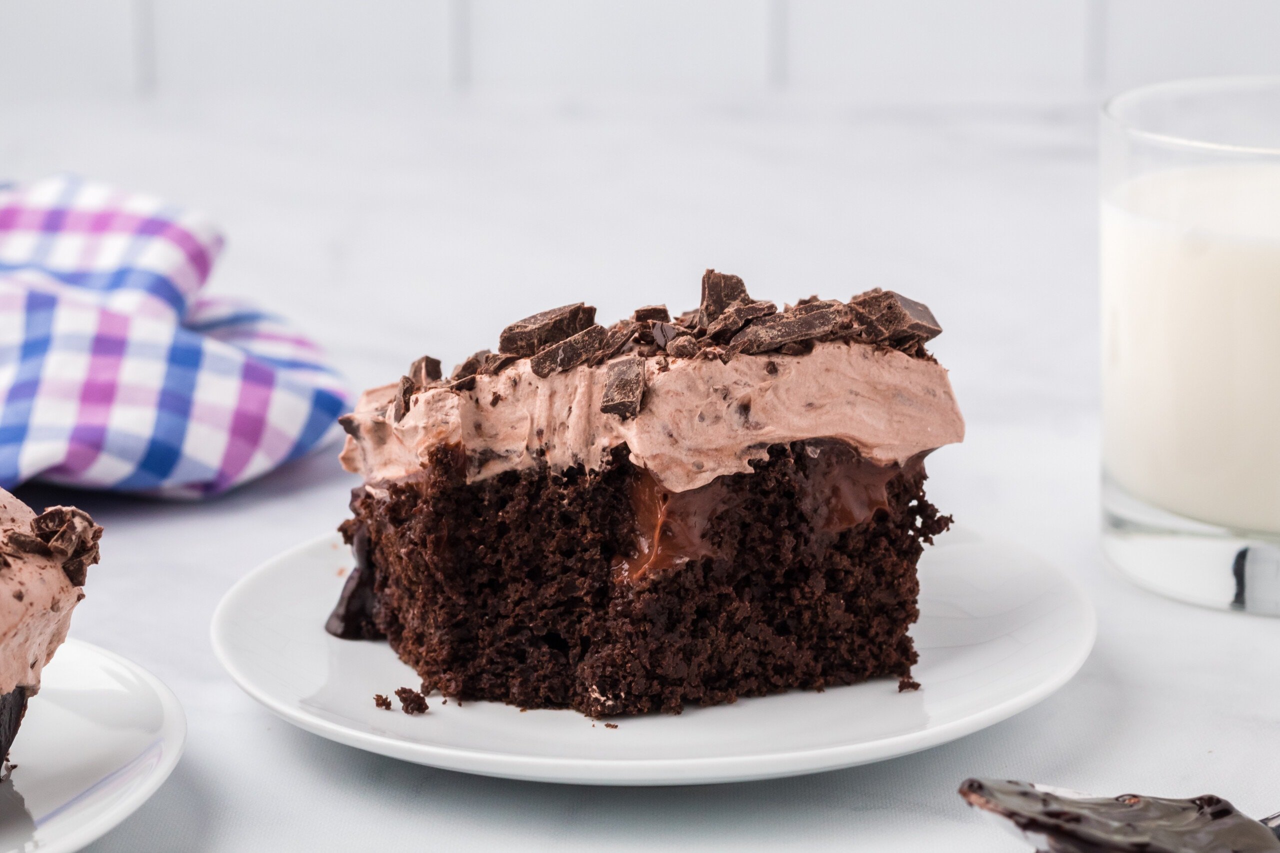 Chocolate Poke Cake with a bite taken out.