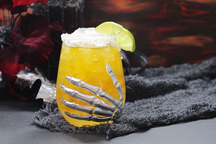 Howling Wolf Margarita in a glass with a skeleton hand.