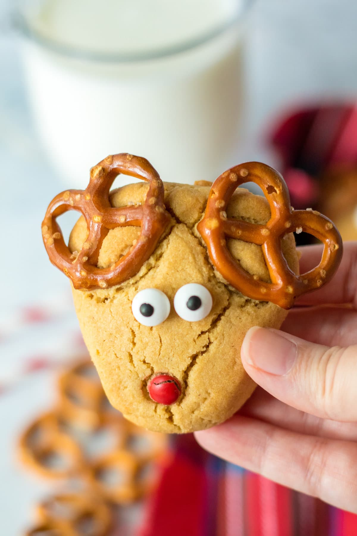 A hand holding one of the Peanut Butter Reindeer Cookies.