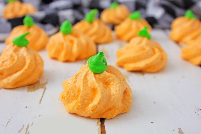 Pumpkin Meringues on a table with a cloth.