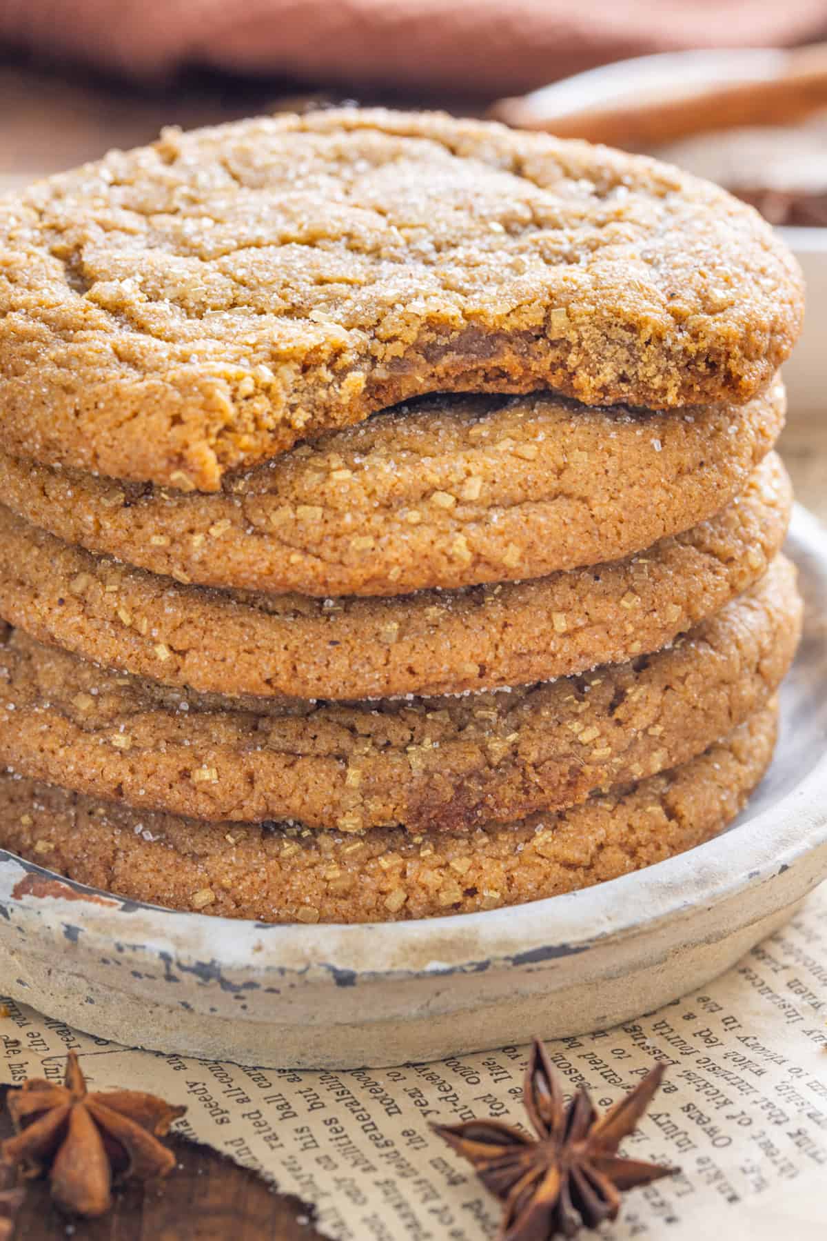 Soft and chewy, these Pumpkin Spice Cookies are perfectly spiced and bake in just 10 minutes! Quick & easy to make. A stack of pumpkin spice cookies, one with a bite missing