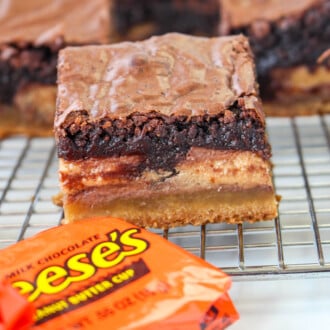 Slutty Brownies with a packaged reese's cup next to it.