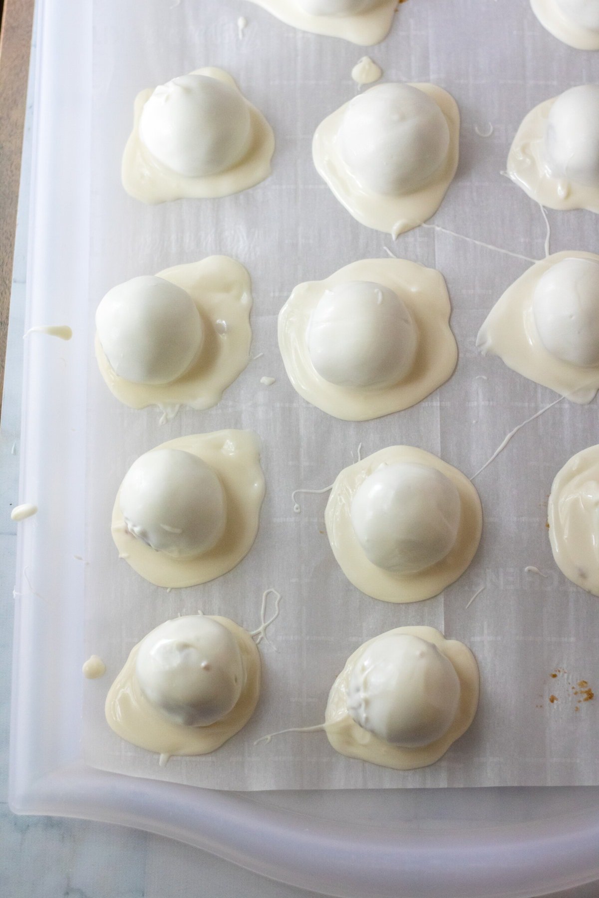 Coating the Snowman Truffles in white chocolate.