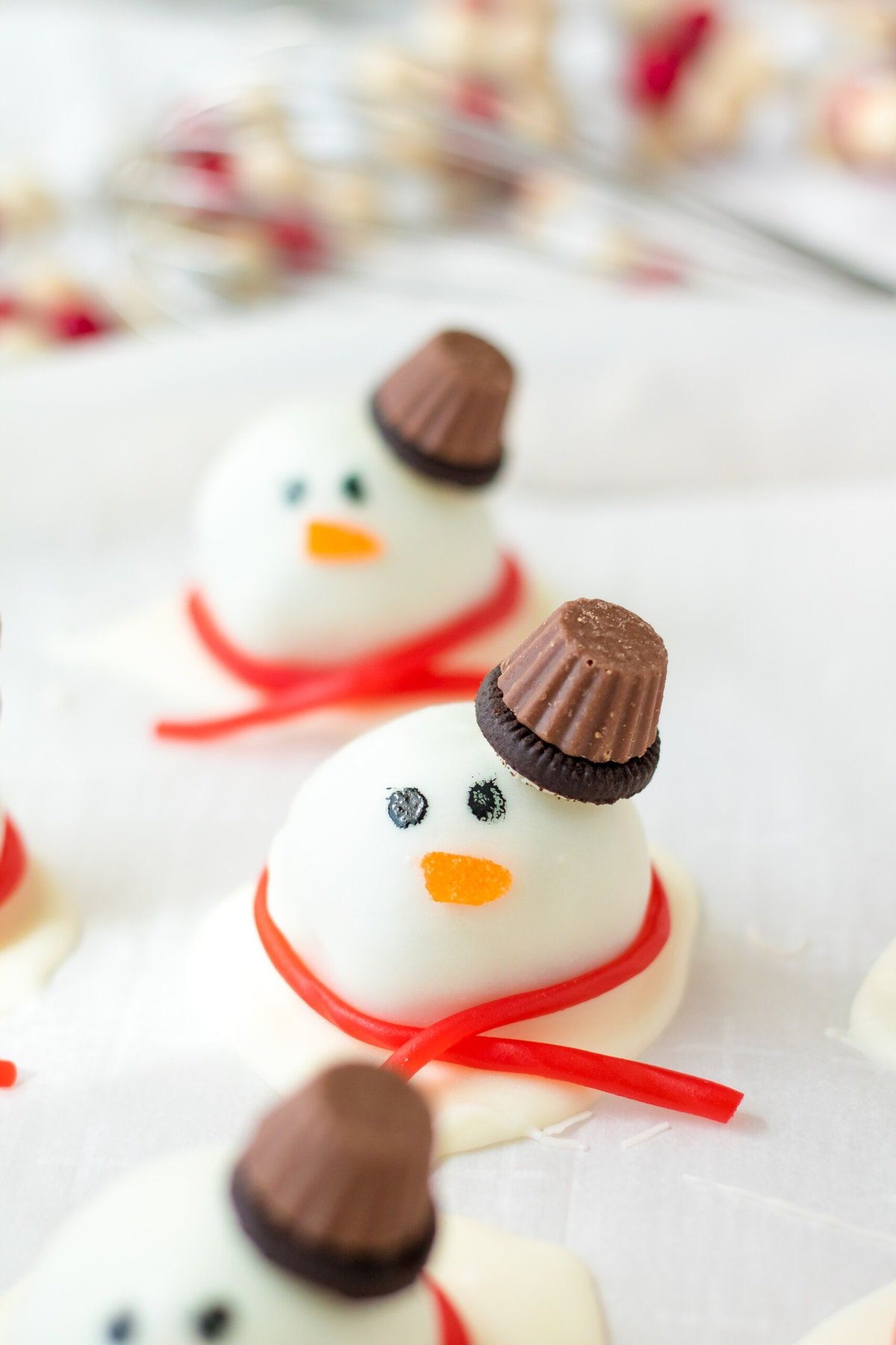 Putting the decorations on the Snowman Truffles.