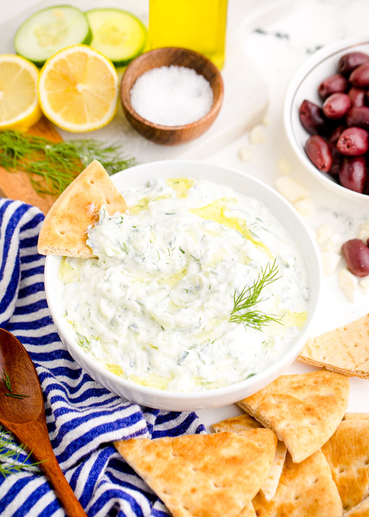 A bowl of tzatziki with a pita in it