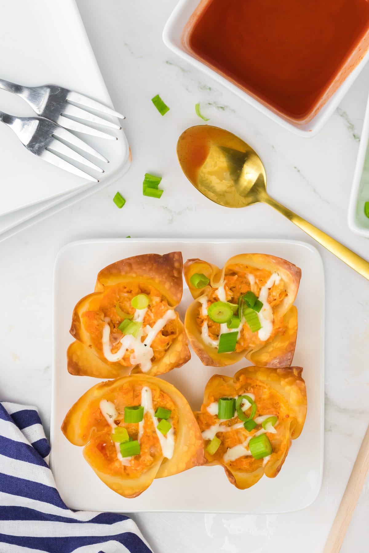 Buffalo Chicken Wontons on a square serving plate.