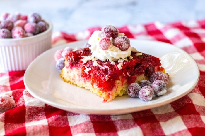 Cranberry Upside-Down Cake with whipped cream on top.
