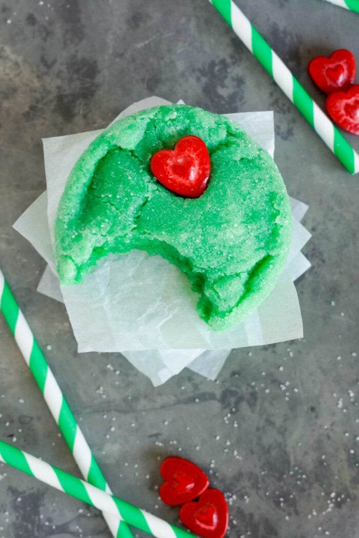 Grinch Cookies with a bite take out on a table.