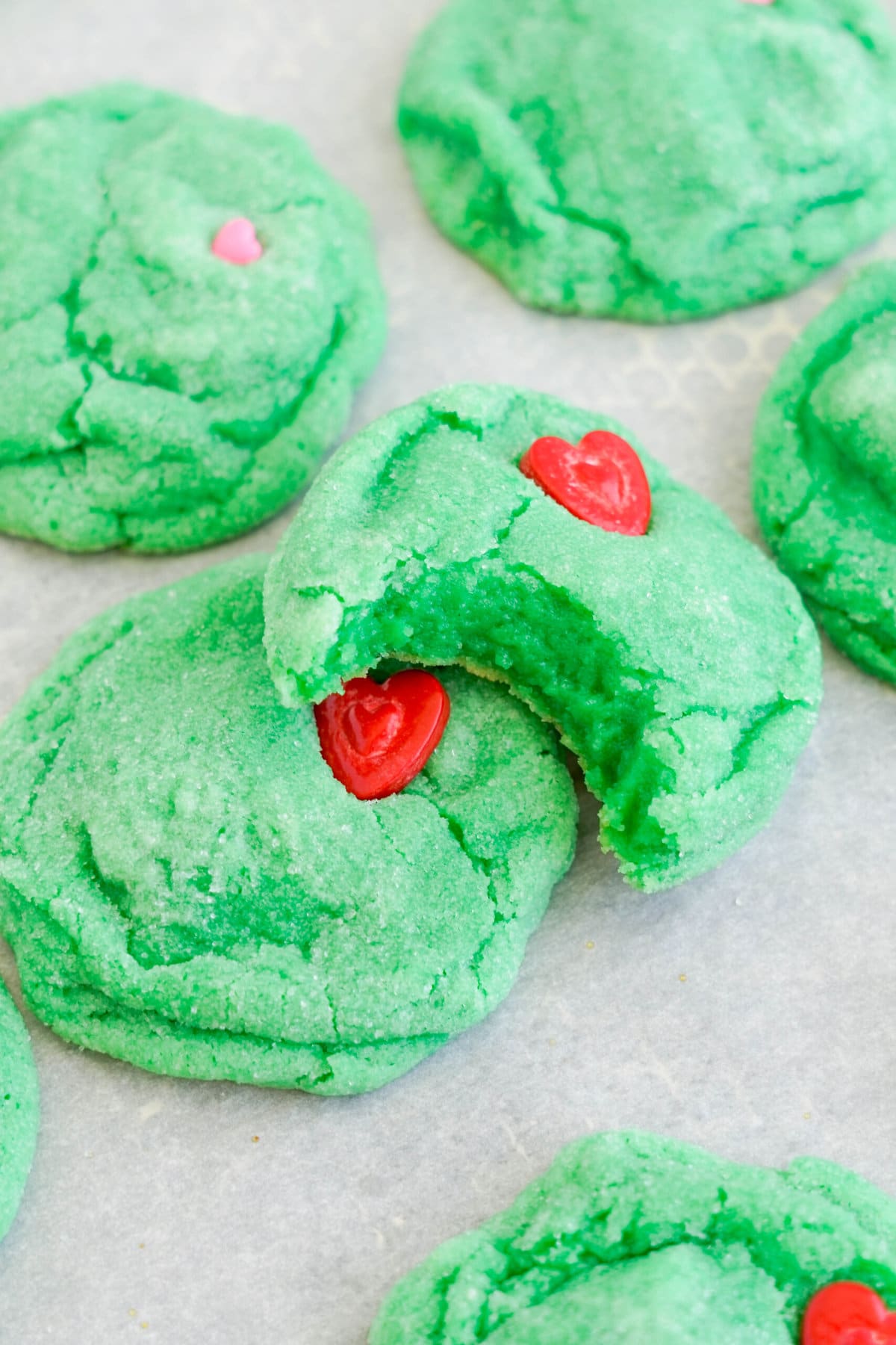Grinch Cookies with a bite taken out.