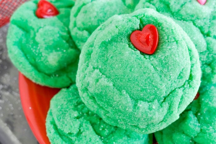 Grinch Cookies on a red bowl.