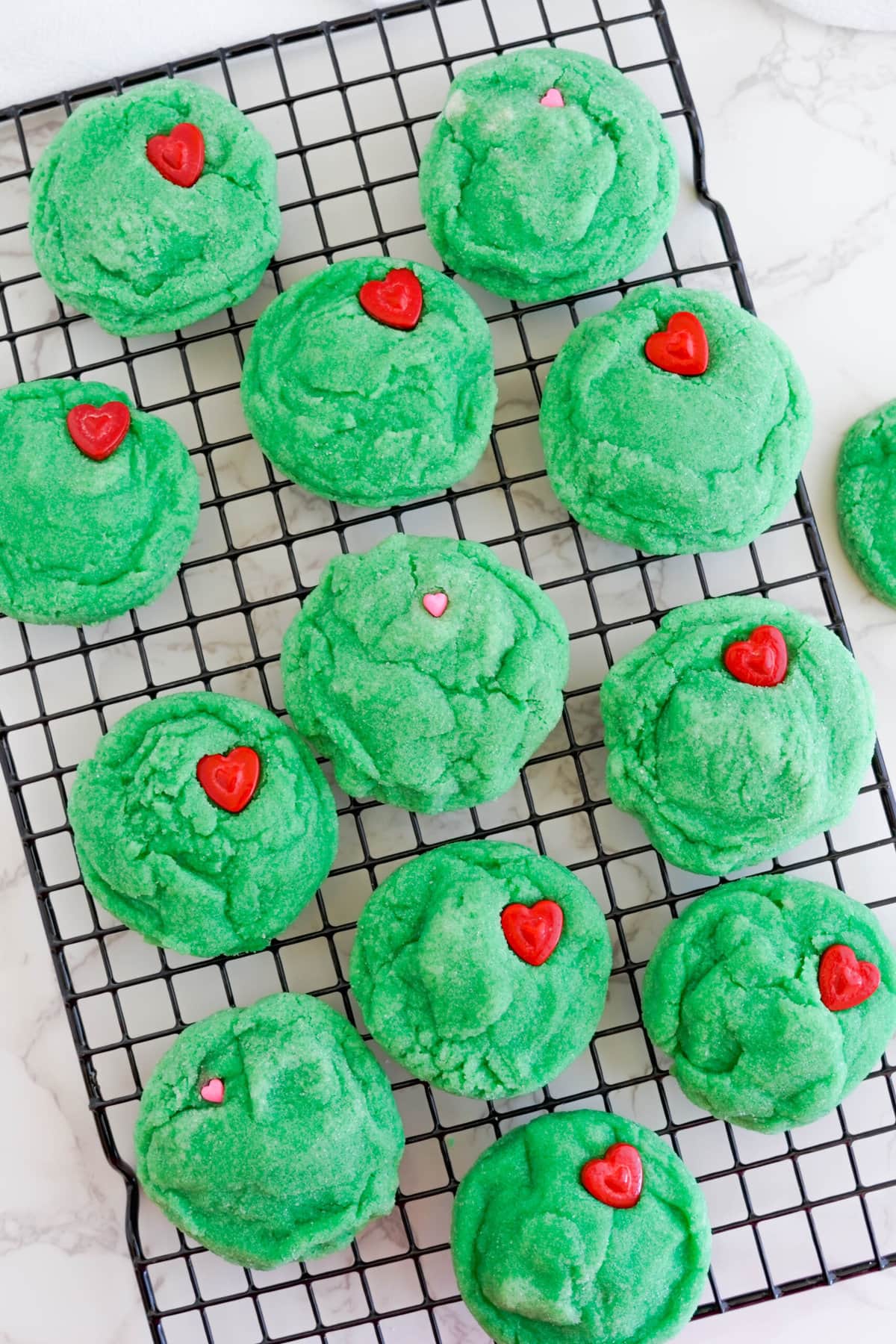Grinch Cookies on a cooling rack.