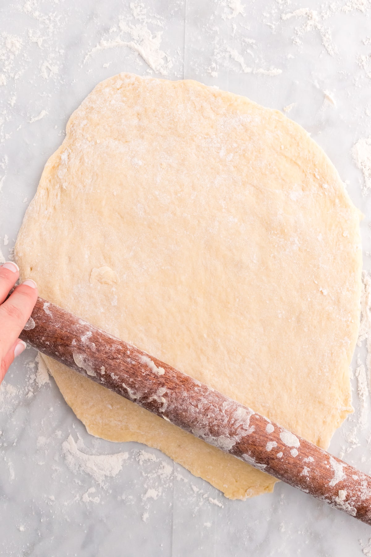 A rolling pin rolling out dough