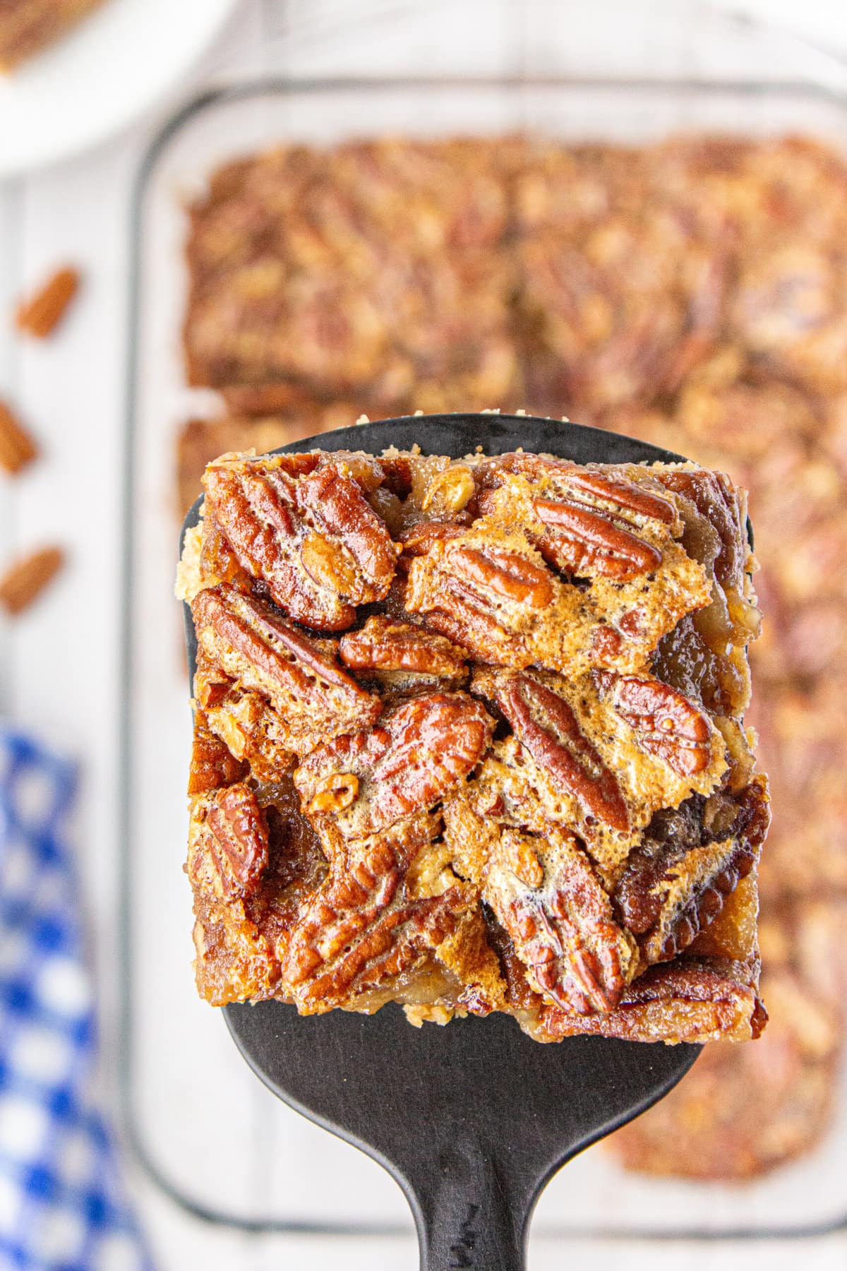 A spatula lifting up one of the Pecan Pie Bars.