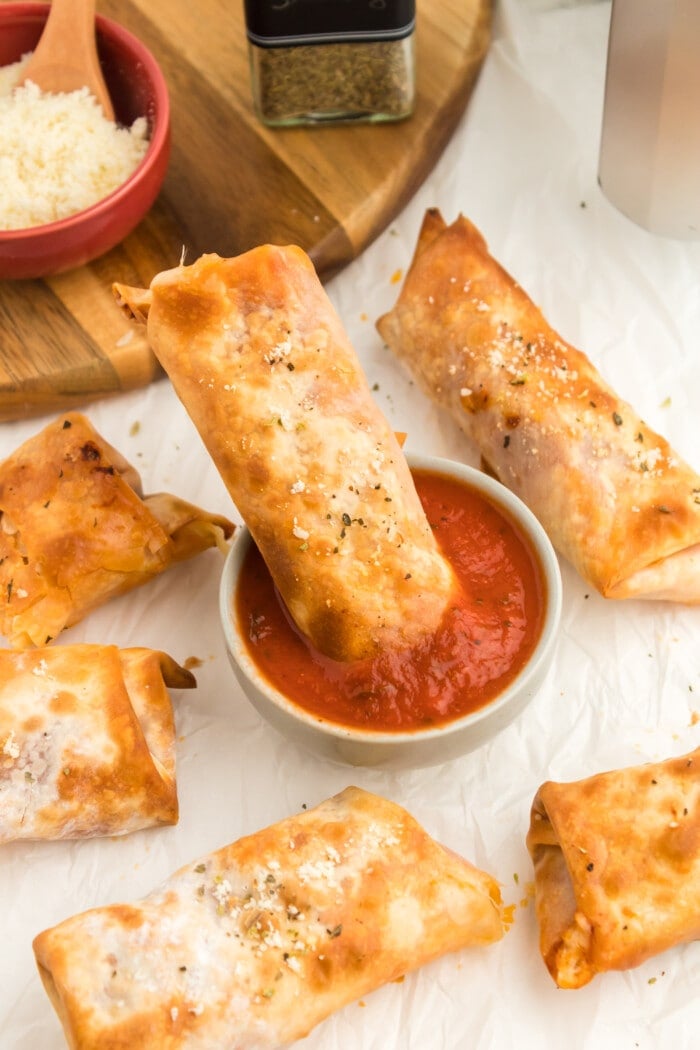 Dipping the Pizza Egg Rolls in sauce.