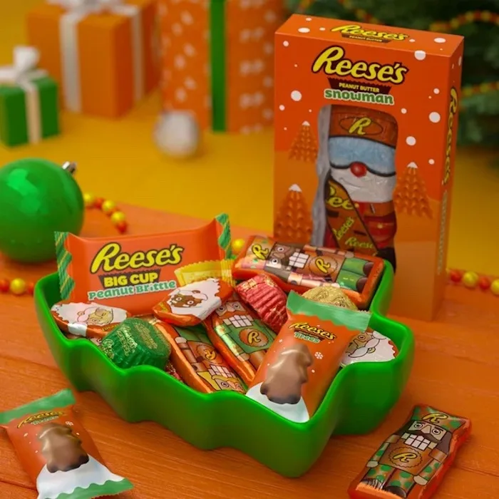 Reese's Holiday Haul candy placed in a green tree serving bowl.