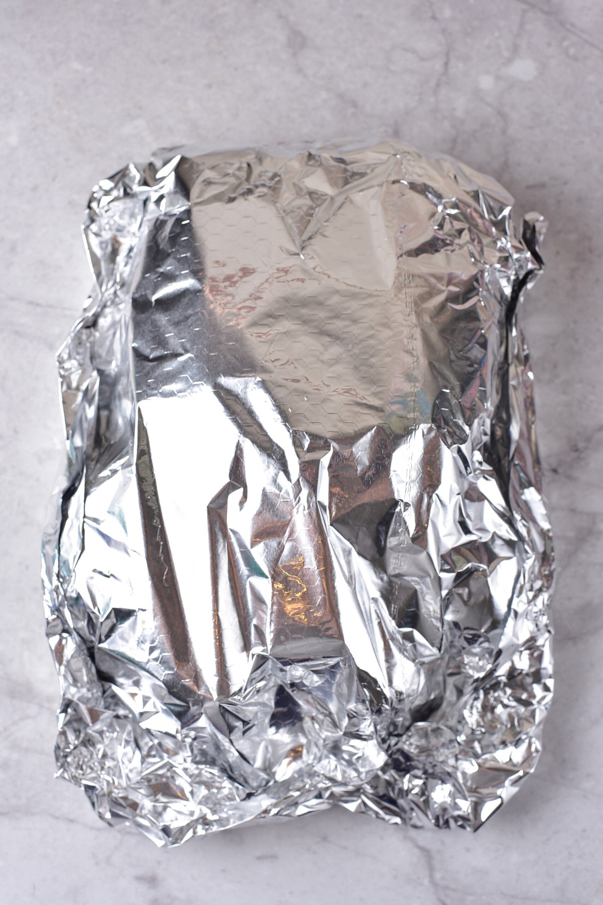 Wrapping the meat with foil.