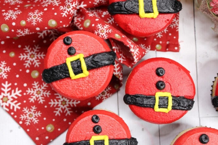 Santa Belly Cupcakes on a wooden table.