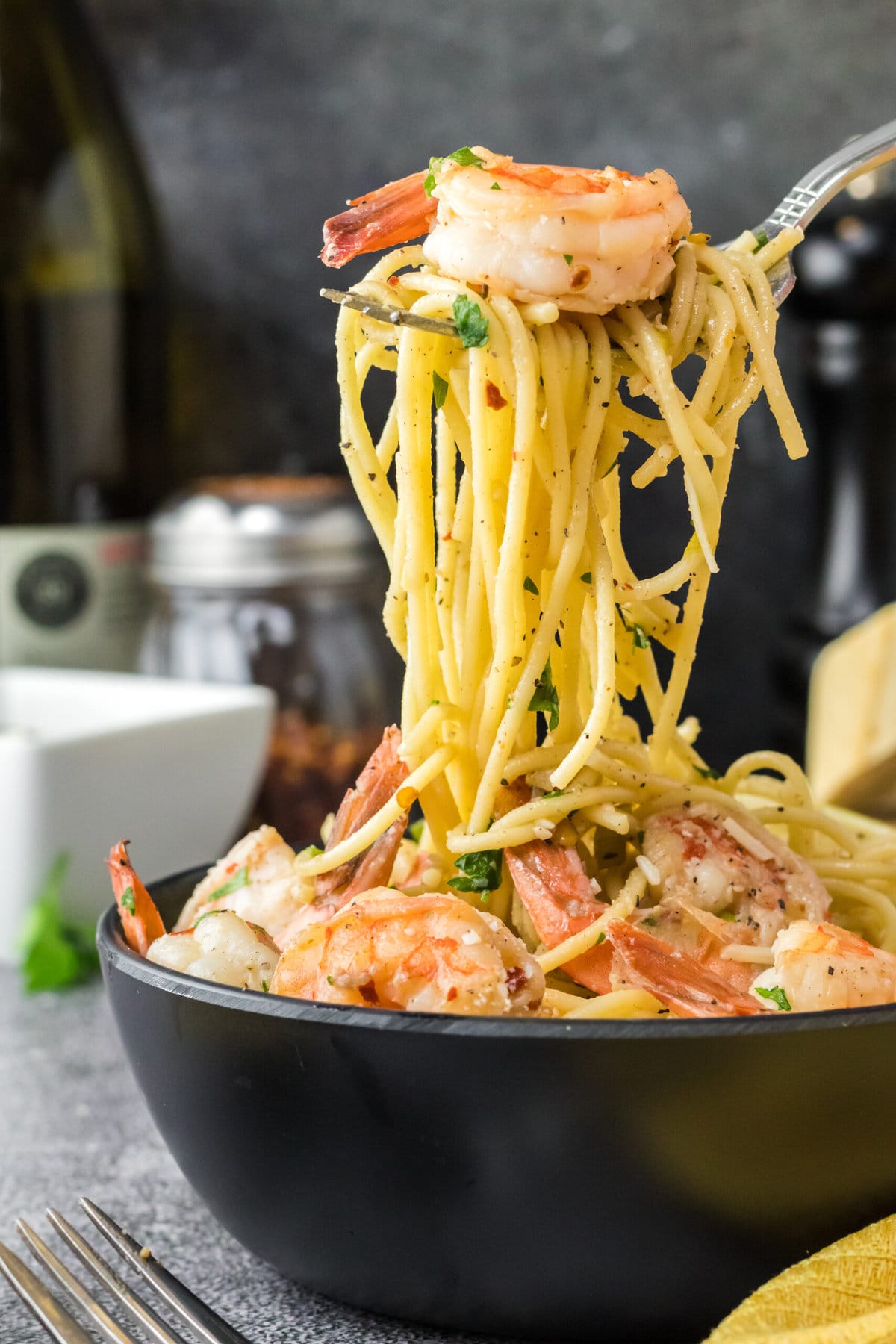 This delicious and Easy Shrimp Scampi Pasta Recipe is ready in a total of 15-minutes! Shrimp Scampi in a black bowl.