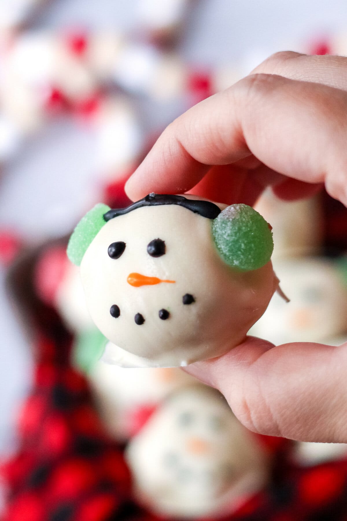 A hand holding a Snowman Brownie Bombs.