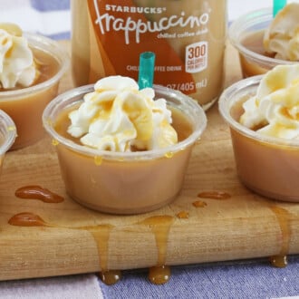 Starbucks Caramel Macchiato Shots with whipped cream on top.