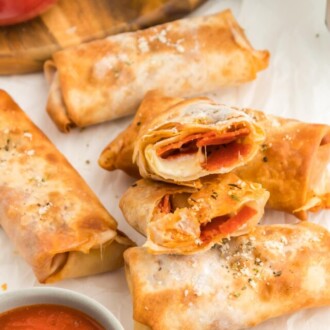 Pizza Egg Rolls on a white table.